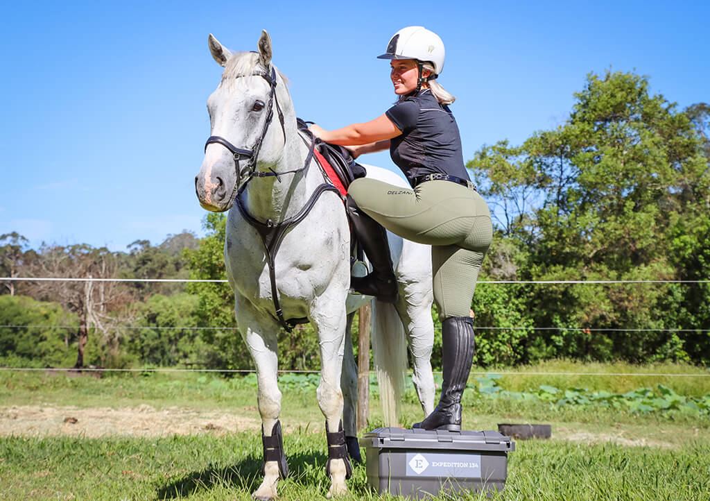 Horse rider stepping to Expedition134 Box to ride a horse
